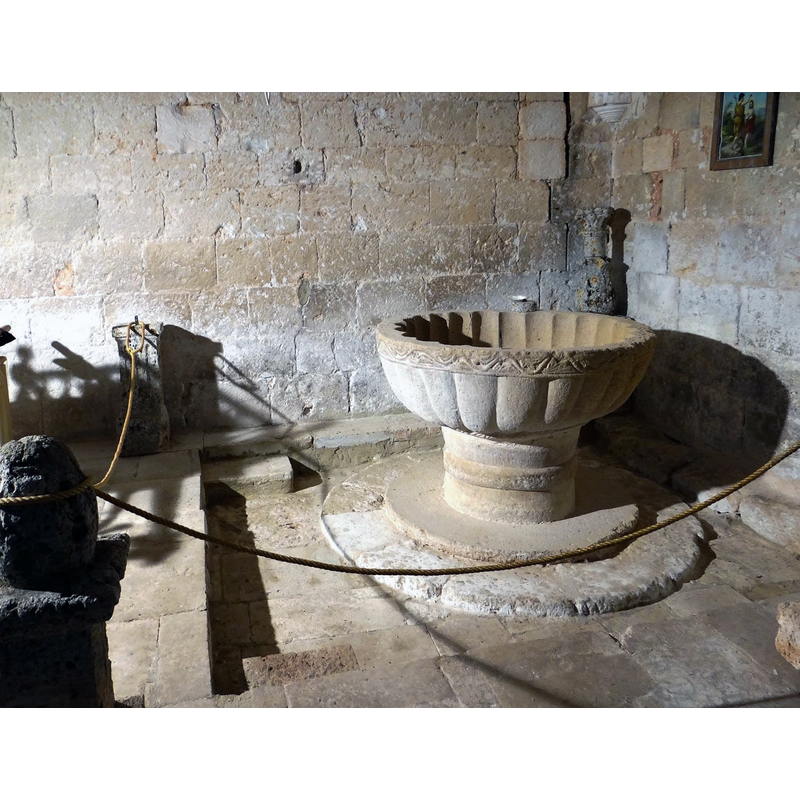 the medieval font in the northeast corner, beneath the gallery