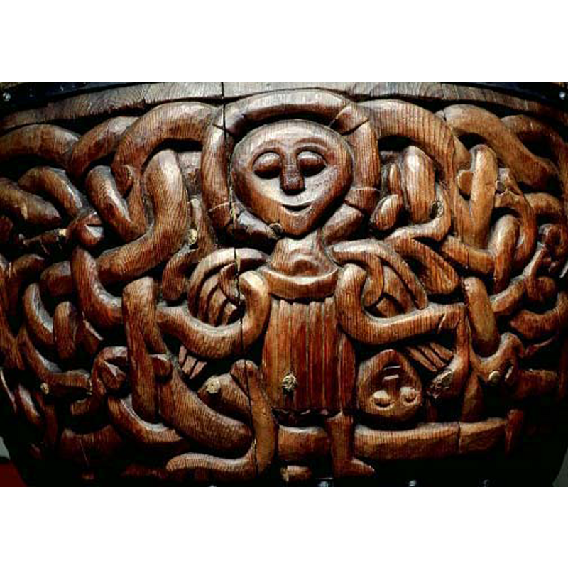 one source identifies this winged and haloed angel as Michael; an upside-down human head is visible in the interlace belo the angel's wing