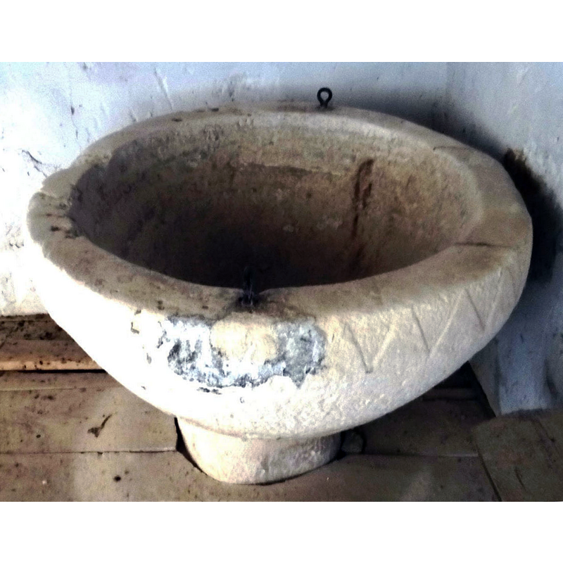 showing the damage and repair on the upper rim, where one of the metal staples is anchored