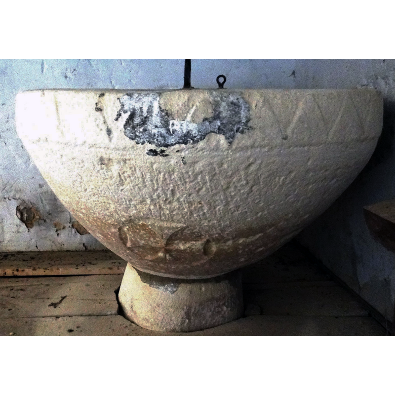 showing the damage and repair on the upper rim, where one of the metal staples is anchored