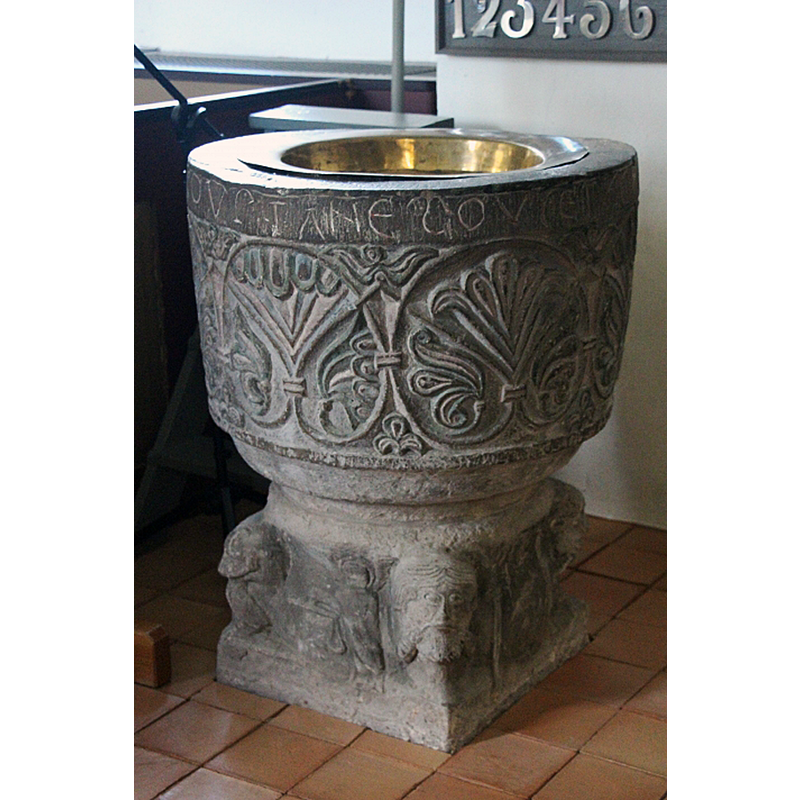 showing the medieval font and its 17thC baptismal dish at the east end, by the psalm board