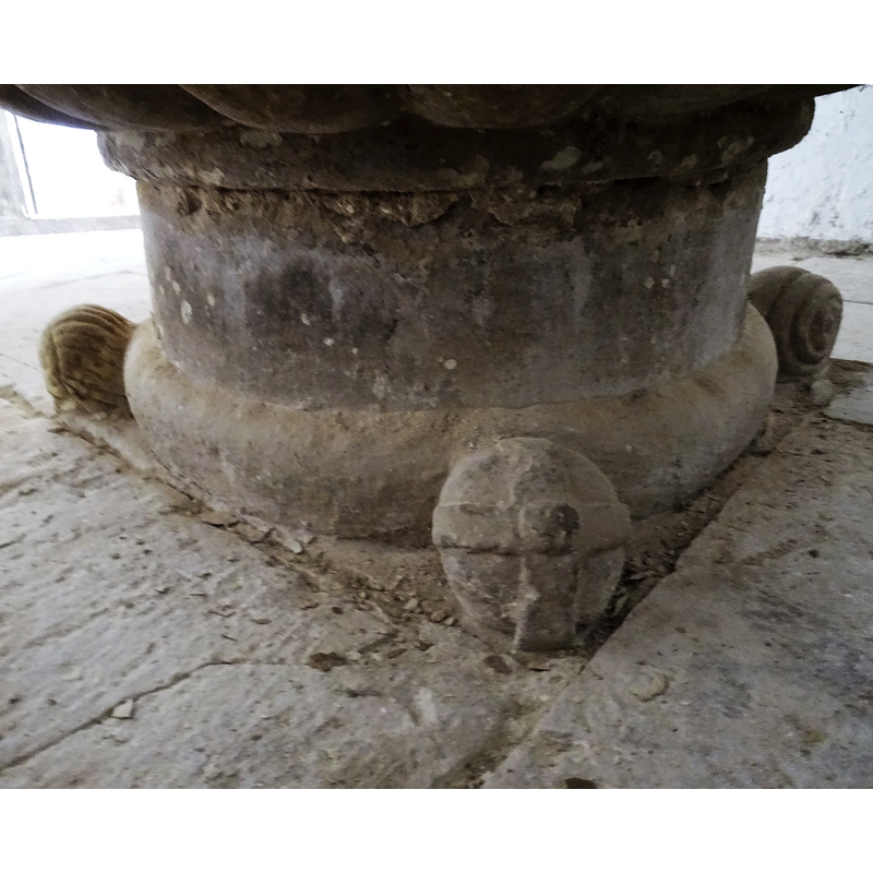 atop the cylindrical pedestal base