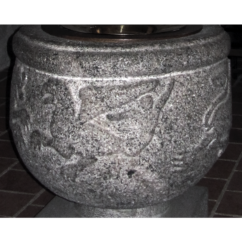 one of two; this one has a strangely-shaped tail; it appears to be engaged in fight with an opposing lion on the left