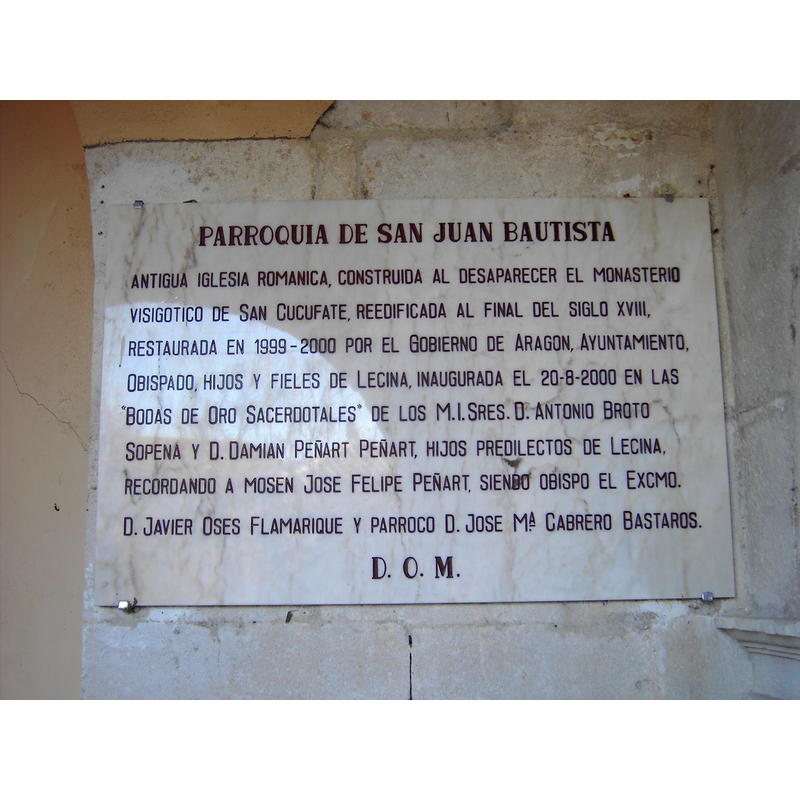 Source caption: "Placa conmemorativa de la iglesia de San Juan Bautista, en Lecina."