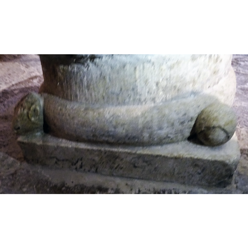 The roll moulding between the corner motifs is the body of a snake.