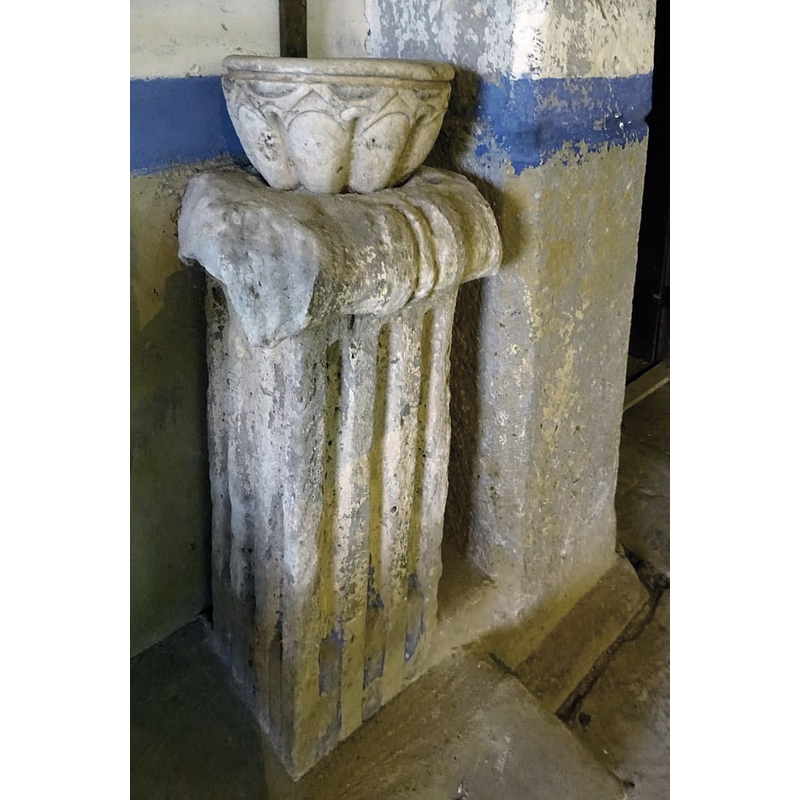 it is located in a corner, against the west wall of the nave