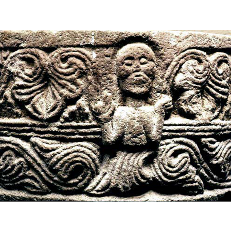 Source caption; "manlig gestalt i bladranka" -- the demi-figures of this font appear to be in an orant position; in other fonts of this group they are bishops in a blessing position