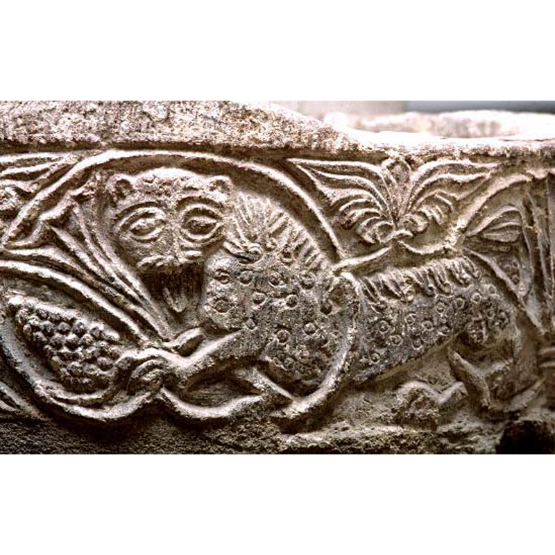 one of several lions caught in the running vine; this one passant to the left