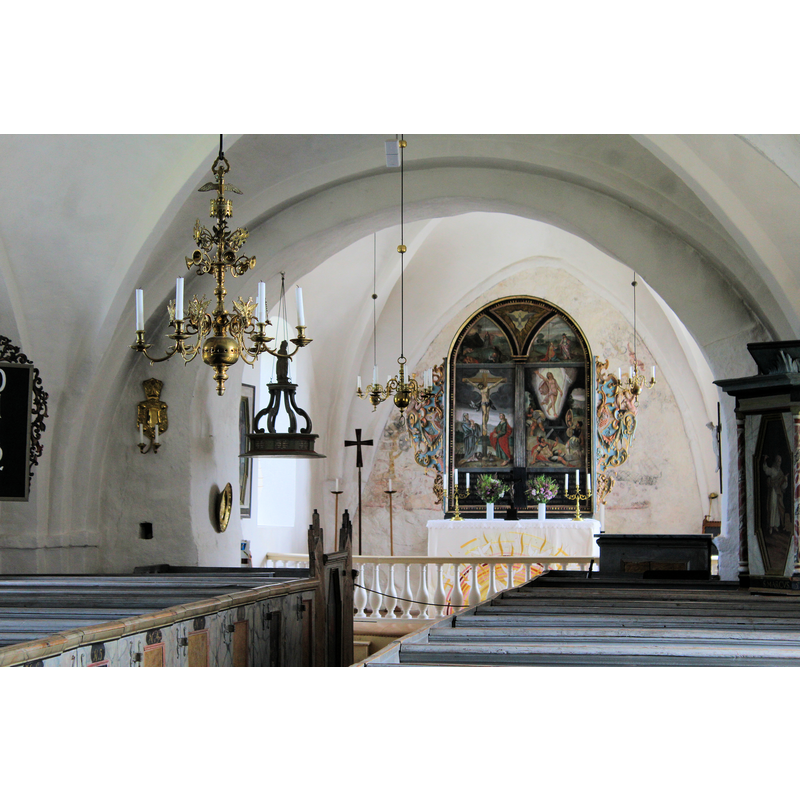 the wooden cover hanging from the ceiling, left side, marks the location of the baptismal font; the round metal [brass?] object hanging on the north wall next to them is probably an early baptismal dish used at some point in this church