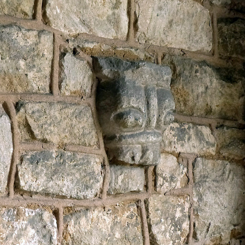 Source caption: "Church of St Mary, North Witham. 12th century carving of a muzzled bear set into the wall of the porch."