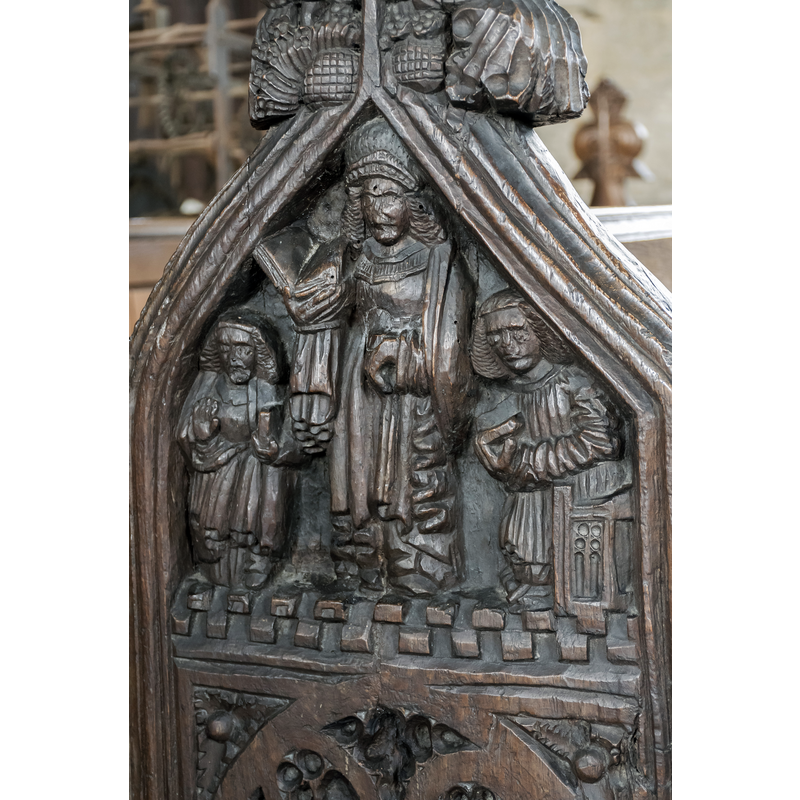 Source caption: "Carved bench end, Ss Peter & Paul church, Osbournby. Depicting religious figures."