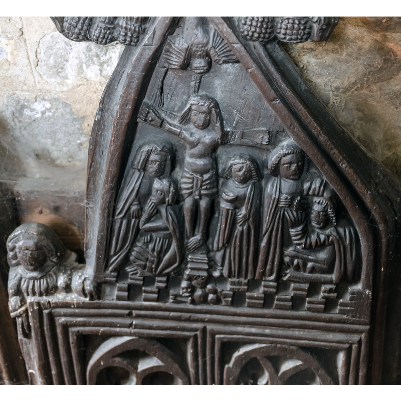 Source caption: "Carved bench end, Ss Peter & Paul church, Osbournby. Medieval carving depicting The Crucifixion."