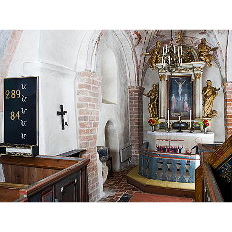 the composite font is partially visible on the left, semi-hidden behind the north pillar of the chancel arch