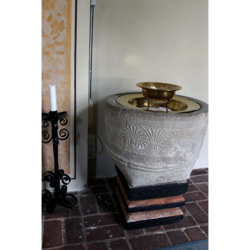 showing the old font and its baptismal dish in the new church at Snårestad