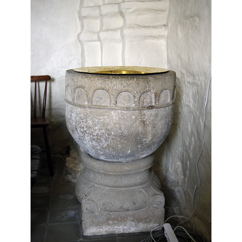 showing the north pillar of the chancel arch behind the font