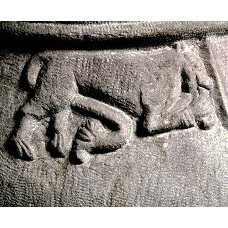 long tail between its hind legs; the almost-human right leg holds something to its maw