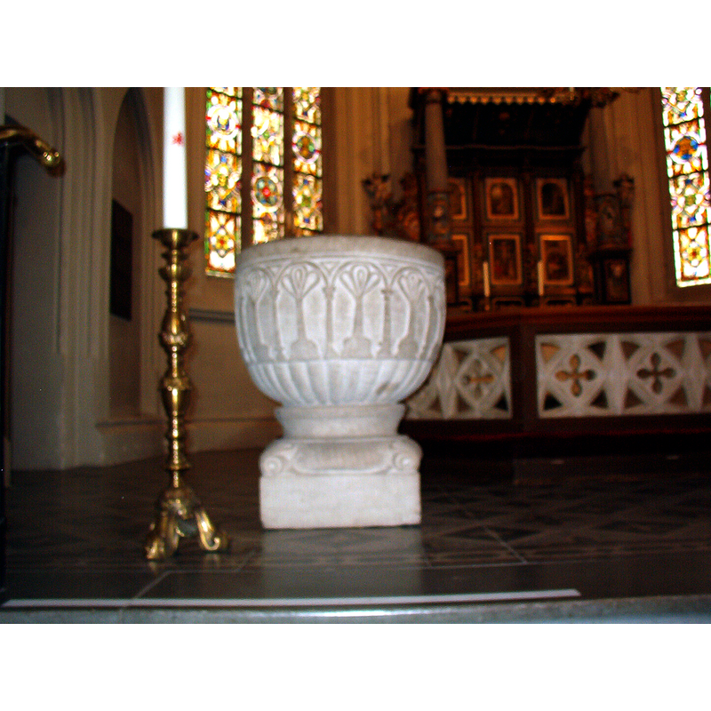 Source caption: 'The baptismal font in Tygelsjö kyrka." -- showing the medieval font, all its paint removed, in the new church [NB: is this font a replica copy of the medieval one? [cf. FontNotes]]