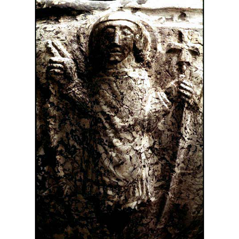 the SHM entry captions thi figure simply as "manligt helgon med korsstav" -- on the north side of the basin