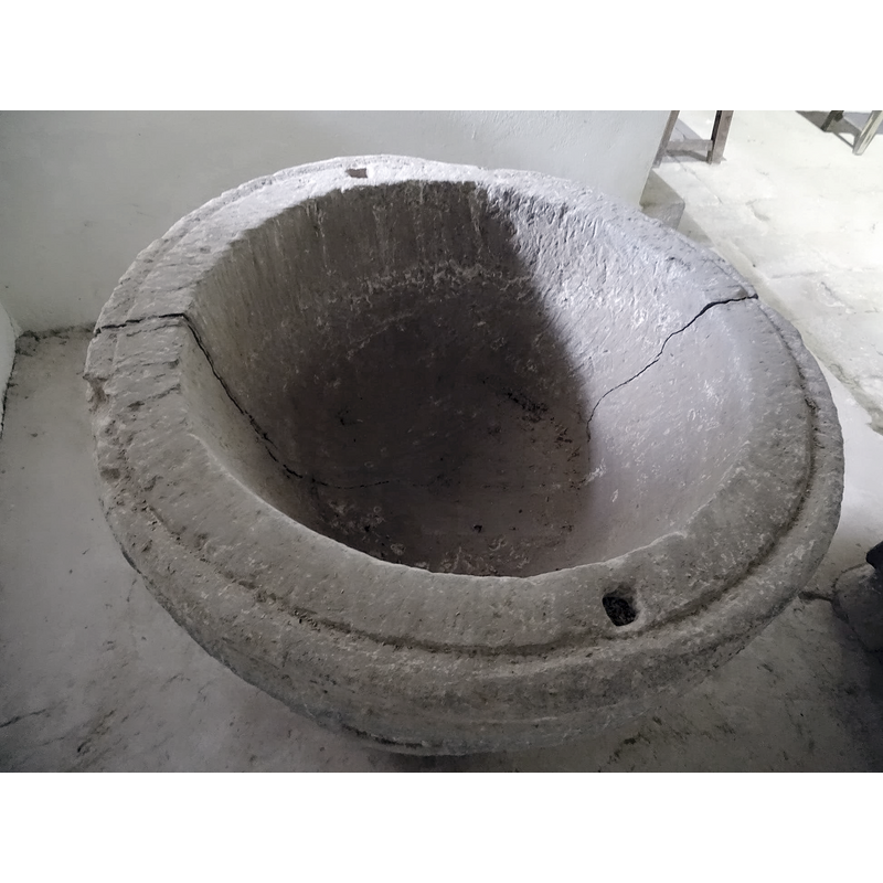 showing the through crack from the inside; no drain visible; two anchorage spots in the upper rim for an earlier font cover?