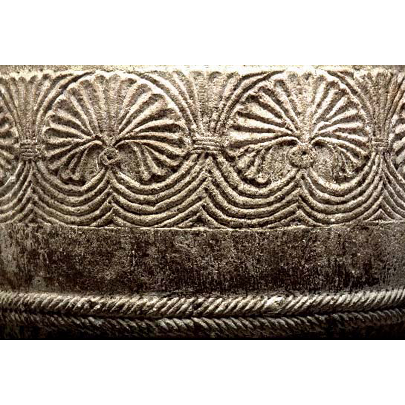 of the charcateristic pattern in this group of font, with tendrils issuing from below and populating the spandrels