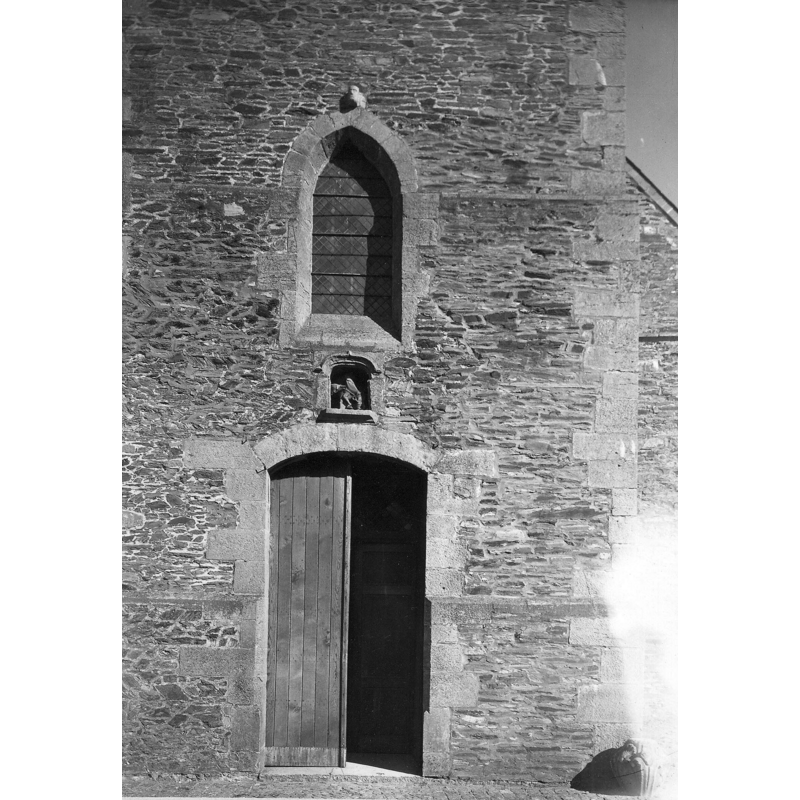 one of the font fragments, a head is visible atop the Gothic window