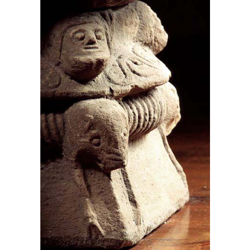 one of the four corners of the base; atop is the huma head; below is animal head or protome