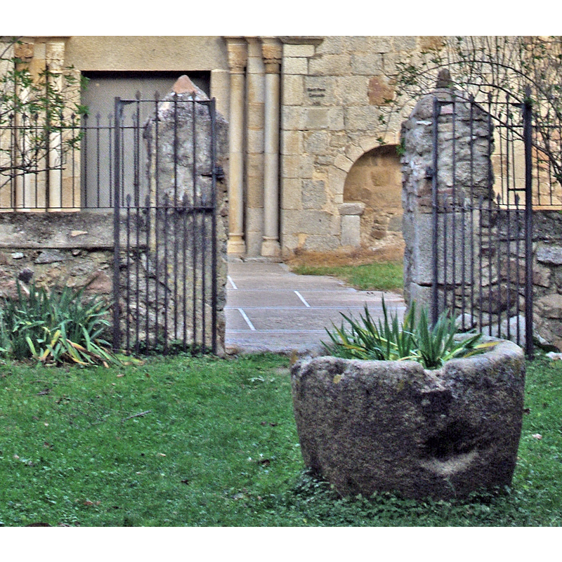 Source caption: "Església de Sant Pere Cercada (Santa Coloma de Farners)" -- the tub vessel seen here, in front of the west portal of the church, may be the discarded medieval font of the monastery church