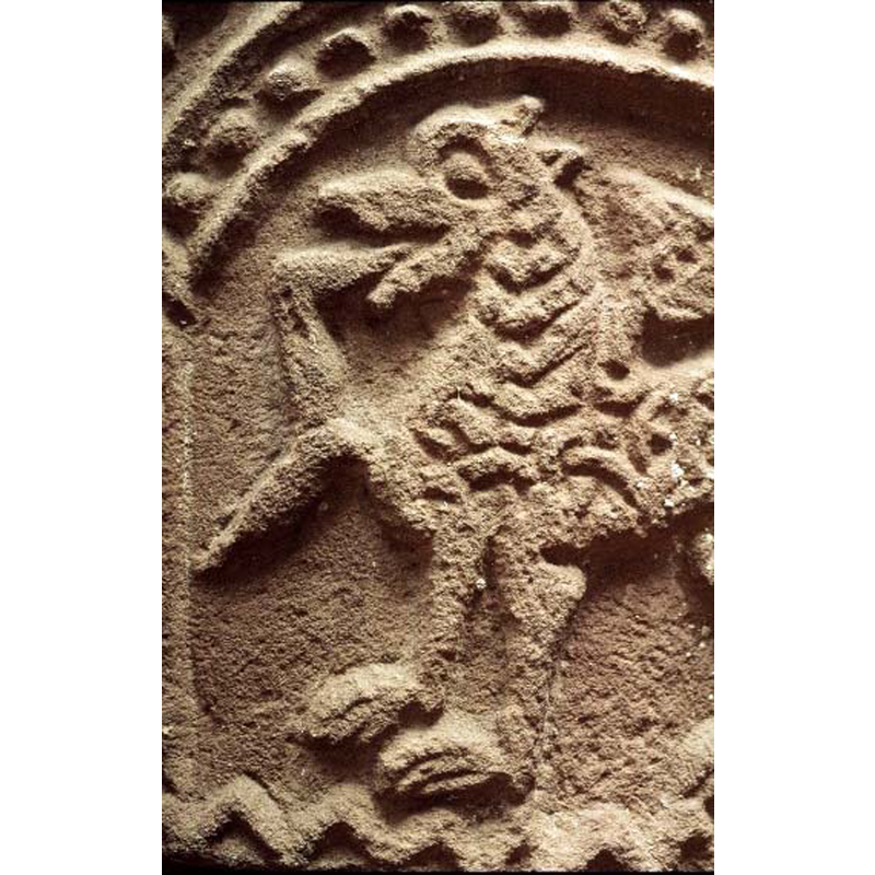 passant to the left; the winged lion has a human leg dangling from its mouth
