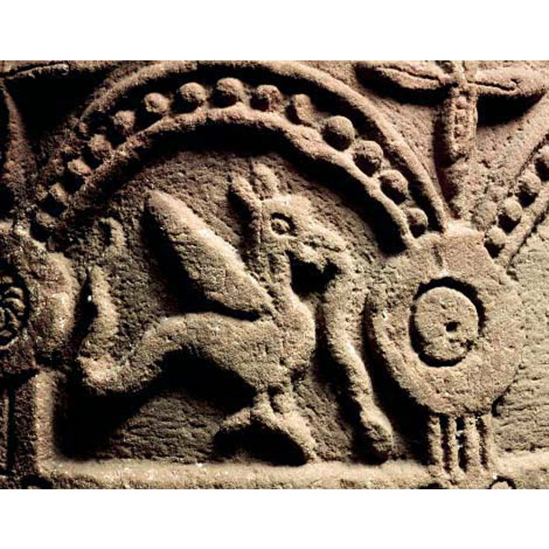 passant to the right; the shape issuing from its mouth appears to be a human extremity