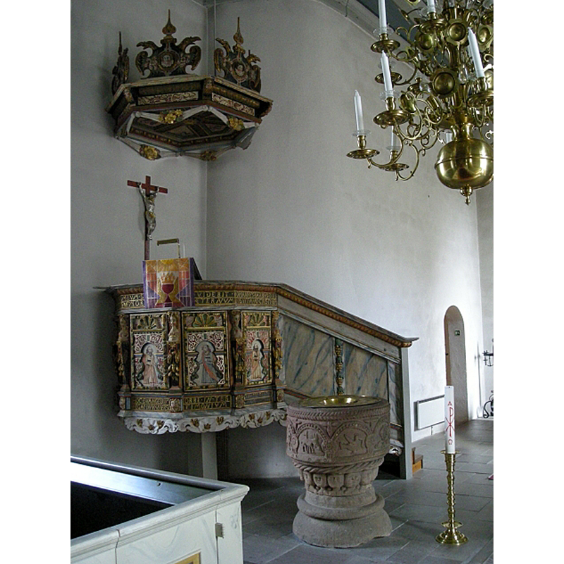 along the north wall, with the sacristy entranceway at the far end