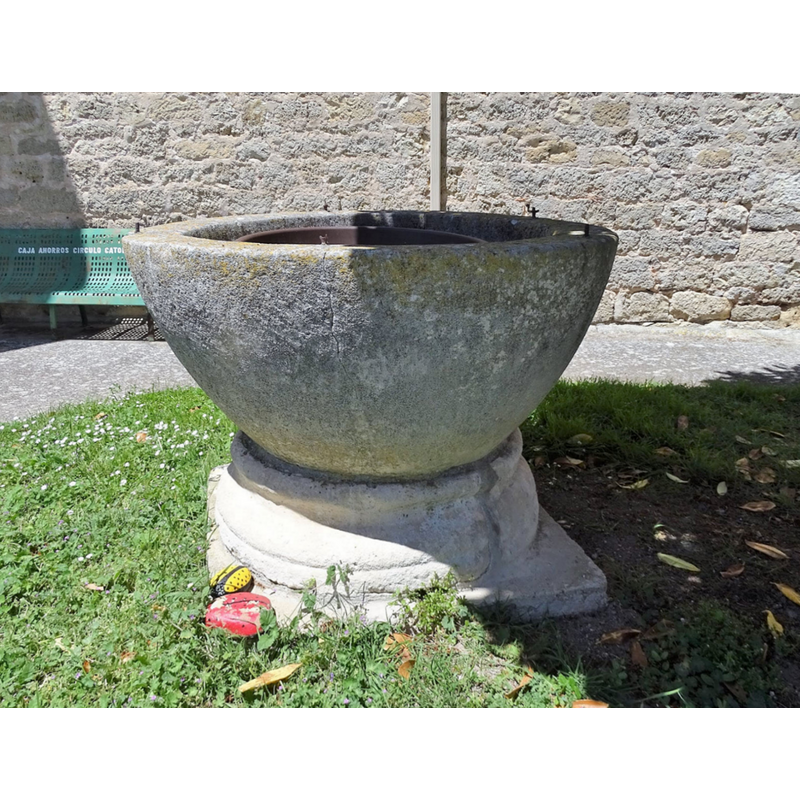 the old font outside the modern church