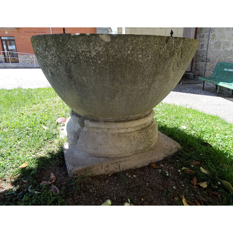 the old font outside the modern church