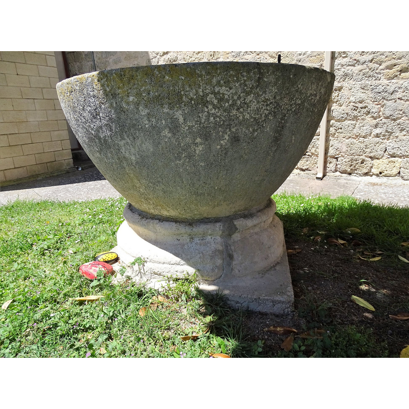 the old font outside the modern church