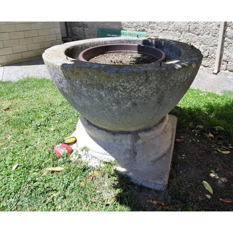 the old font outside the modern church