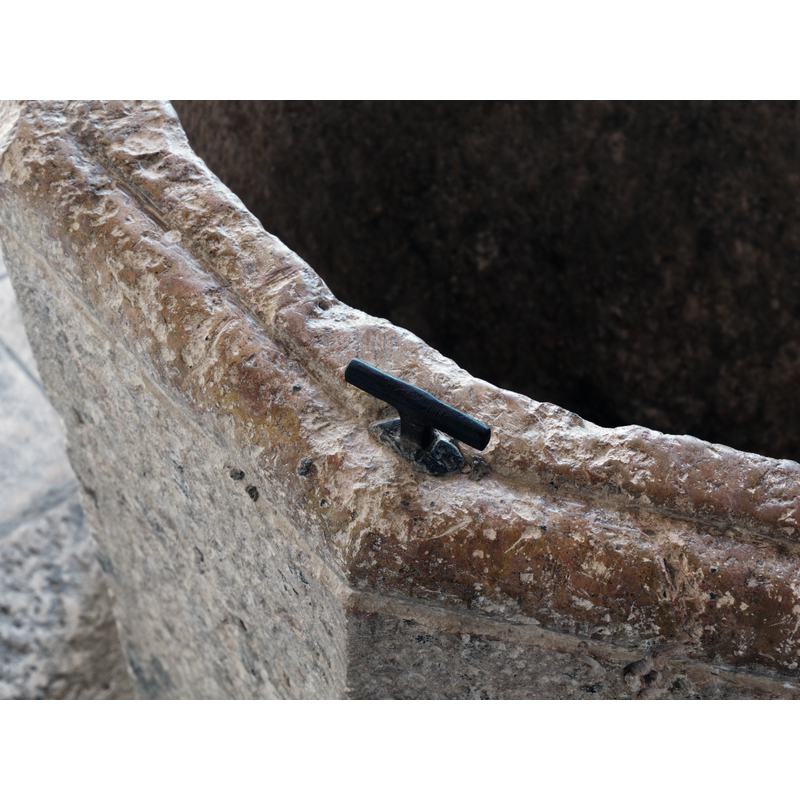 showing one of the two metal staples to anchor a font cover