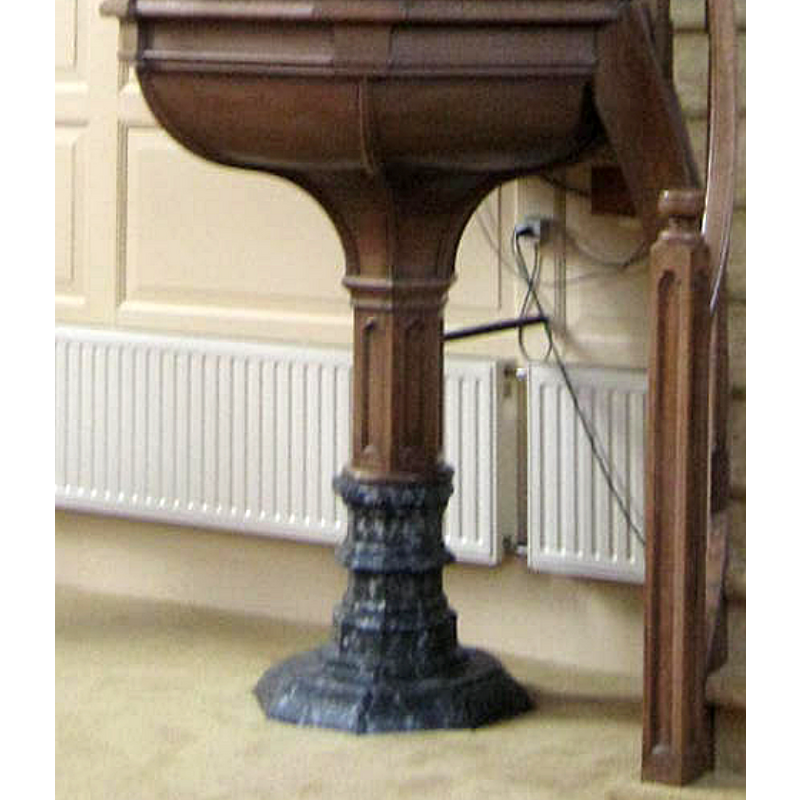 the base of the pulpit is said to be the remains of the baptismal font from the old church