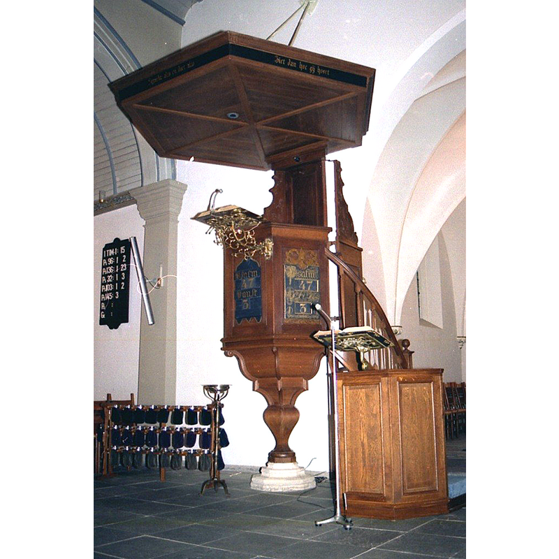 the stone base of the pulpit is said to be part of an earlier font here but it probably was not [cf. FontNotes]  -- notice also the actual baptismal font in use, a tiny bowl of netal on a stand to the left of the pulpit base