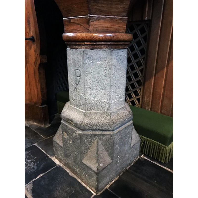 the re-used base of an earlier stone font