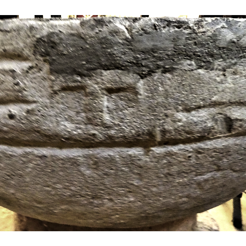 the cross and the crude roll moulding appear to be the only decoration on the font; the cross may have been carved on it at a later period