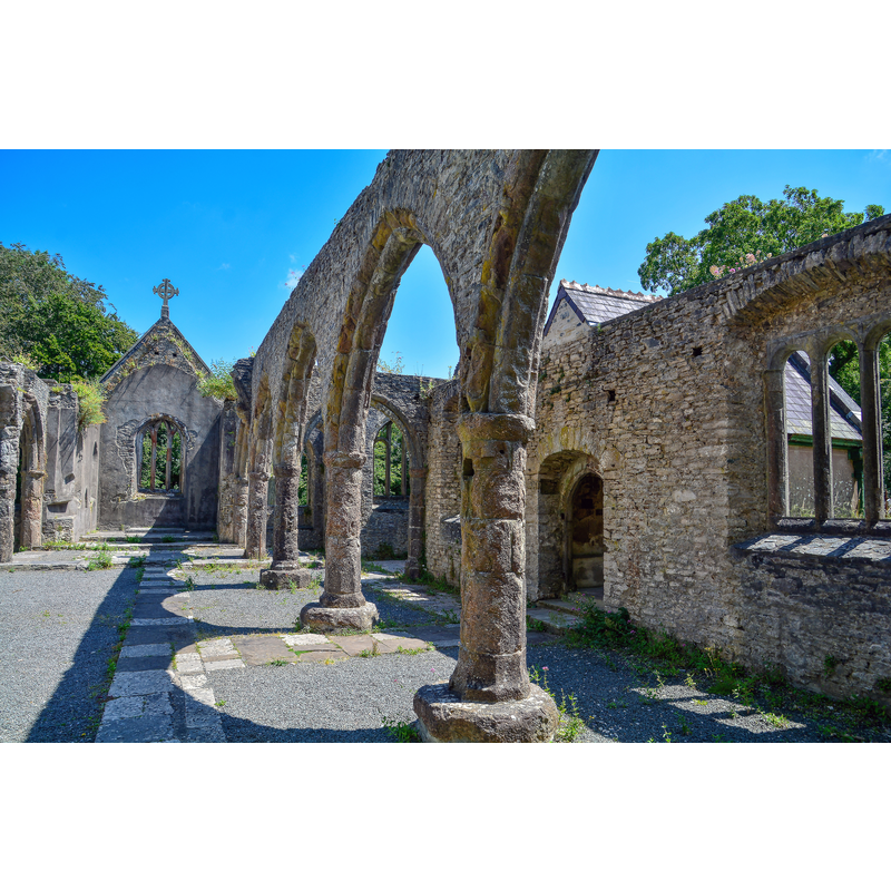 Source caption: "Buckfastleigh : Holy Trinity Church. The nave and chancel were gutted by arson in July 1992. Services are still held occasionally, and the churchyard still receives burials."