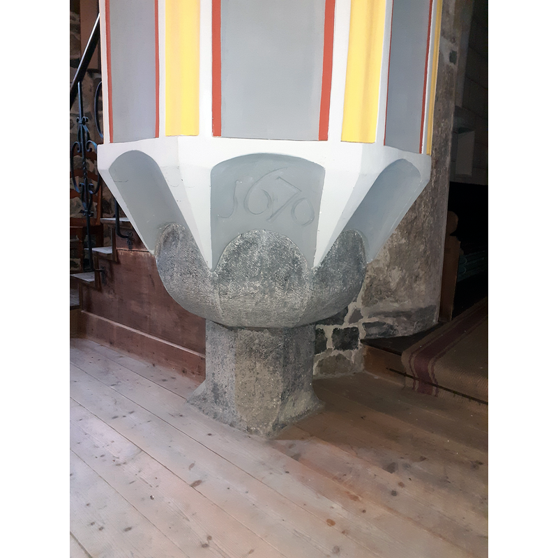 mounted on an ancient baptismal font