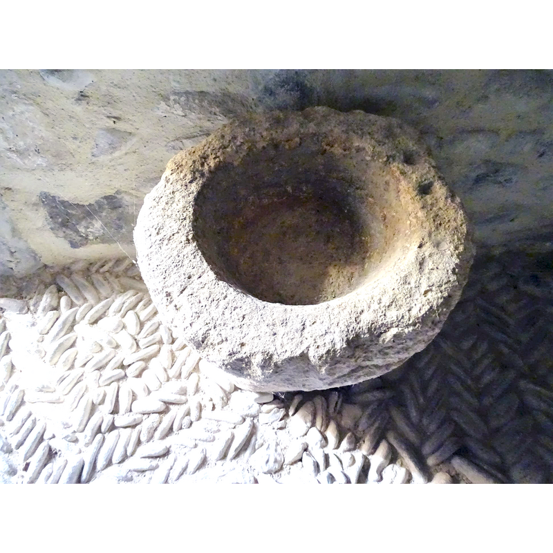 no drain hole; the pair of drilled holes in the rim may suggest that they may have been made to anchor a cover in them; was this stoup used as a replacement font for a time?