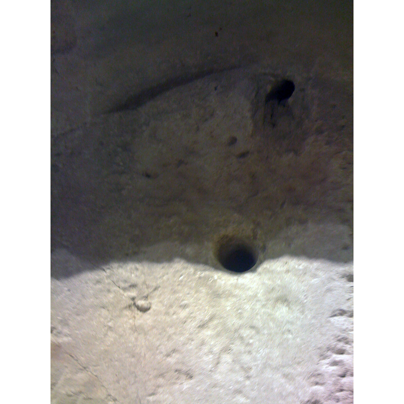 the hole in the centre appears to be the original drain; the others are probably from the use of this object as a trough or planter