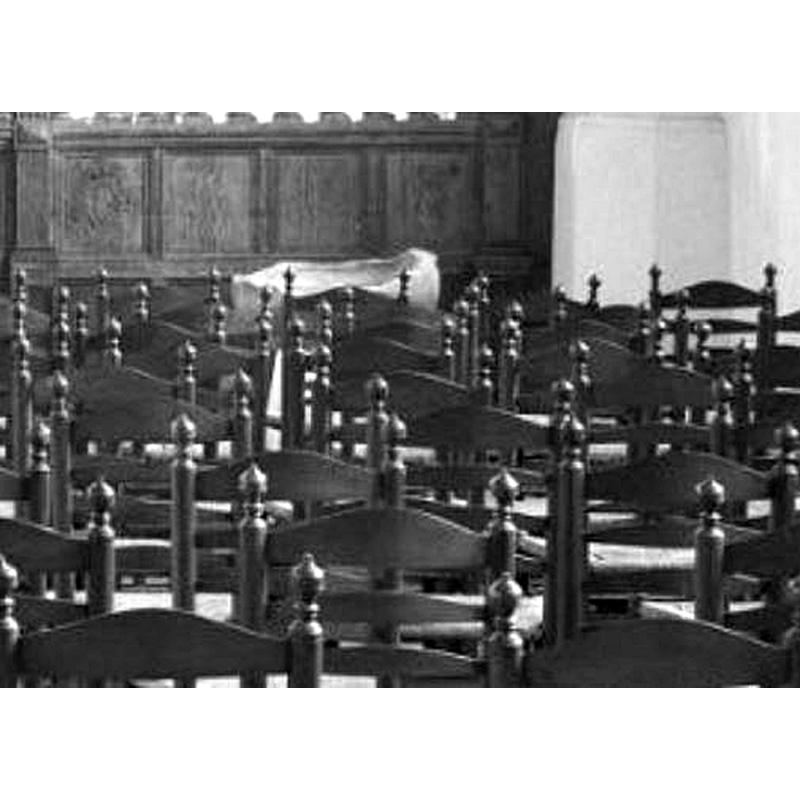 the top part of the basin of the old font is discernible here behind the chairs