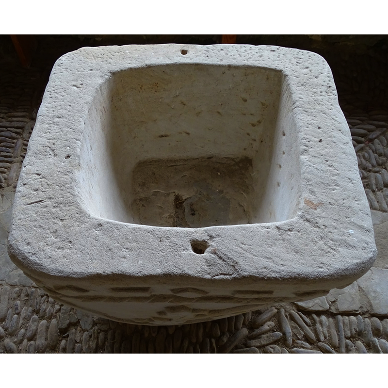 the newly re-carved font, still in the porch in 2021, showing the drain hole