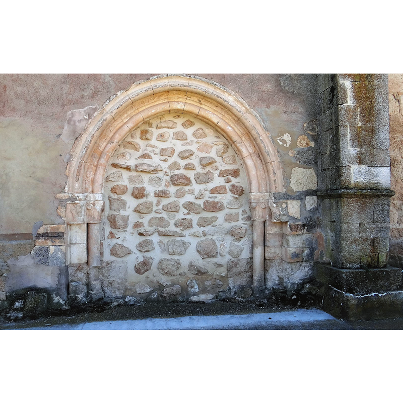 the blocked Romanesque portal on the north side