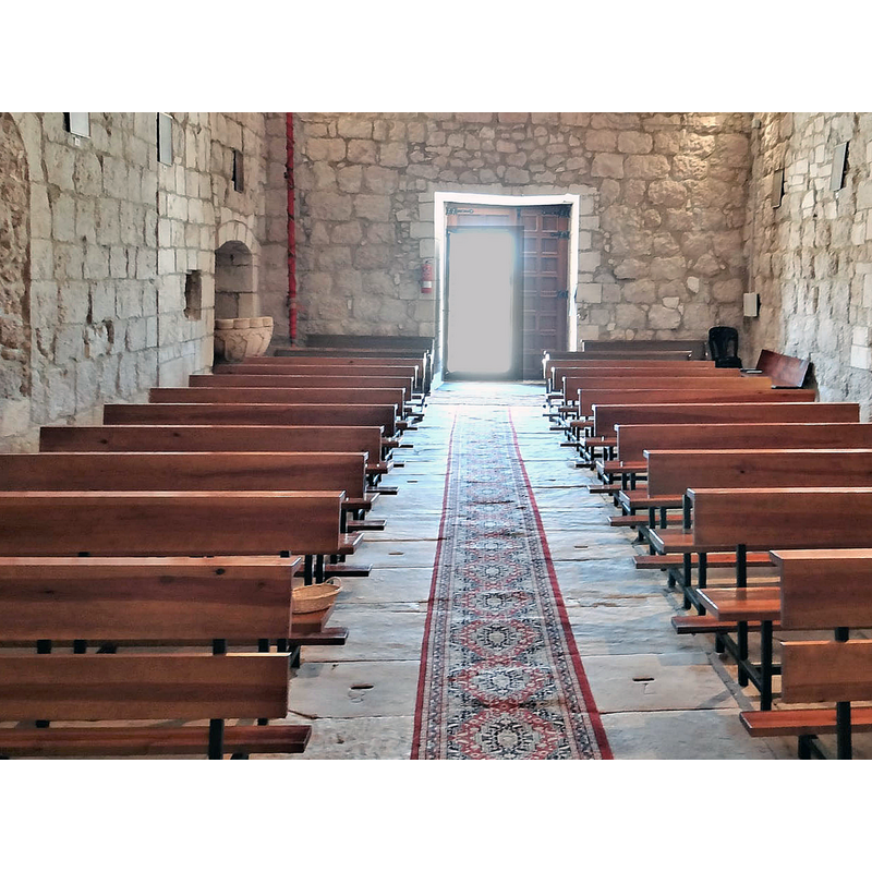 partially showing the baptismal font in the southwest corner of the nave, left of the west entranceway
