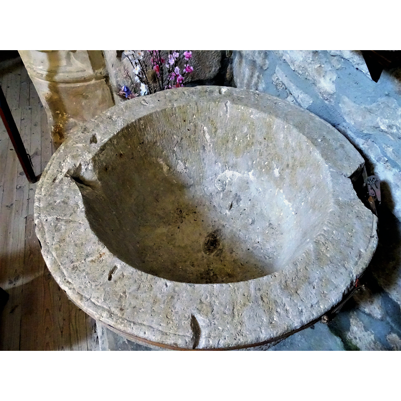 showing the basin interior with its drain hole, as well as the damages around the upper rim