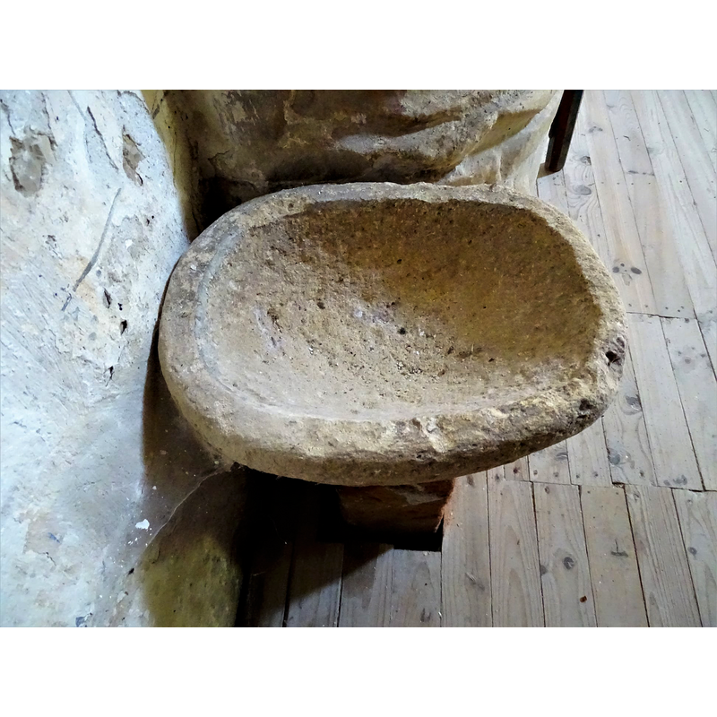 this object is set up now as a stoup in the proximity of the baptismal font, but it appears to be a composite of two unrelated parts, the upper one perhaps a former grain measure or similar, rather than a liturgical furnishing