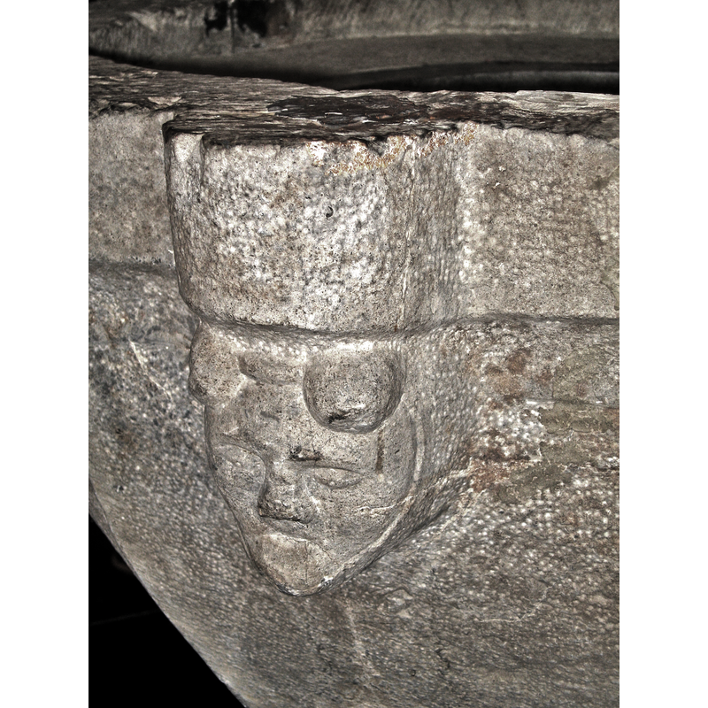 the bulges on the forehead have been interpreted by some as devil's horns, but they are more likely an ornamental part of the head-dress